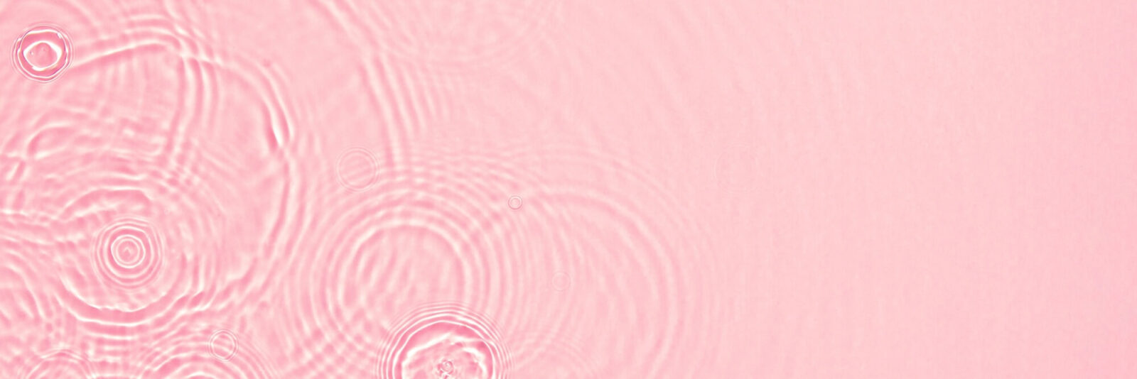 Abstract summer banner background Transparent pink clear water surface texture with ripples, splashes and bubbles.