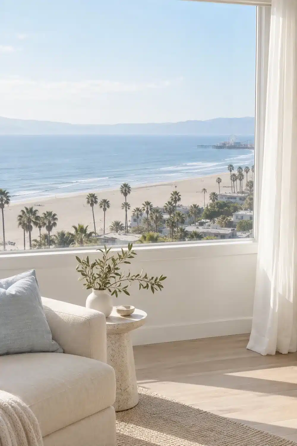 Living room window overlooking Santa Monica beach, the pier and palm trees